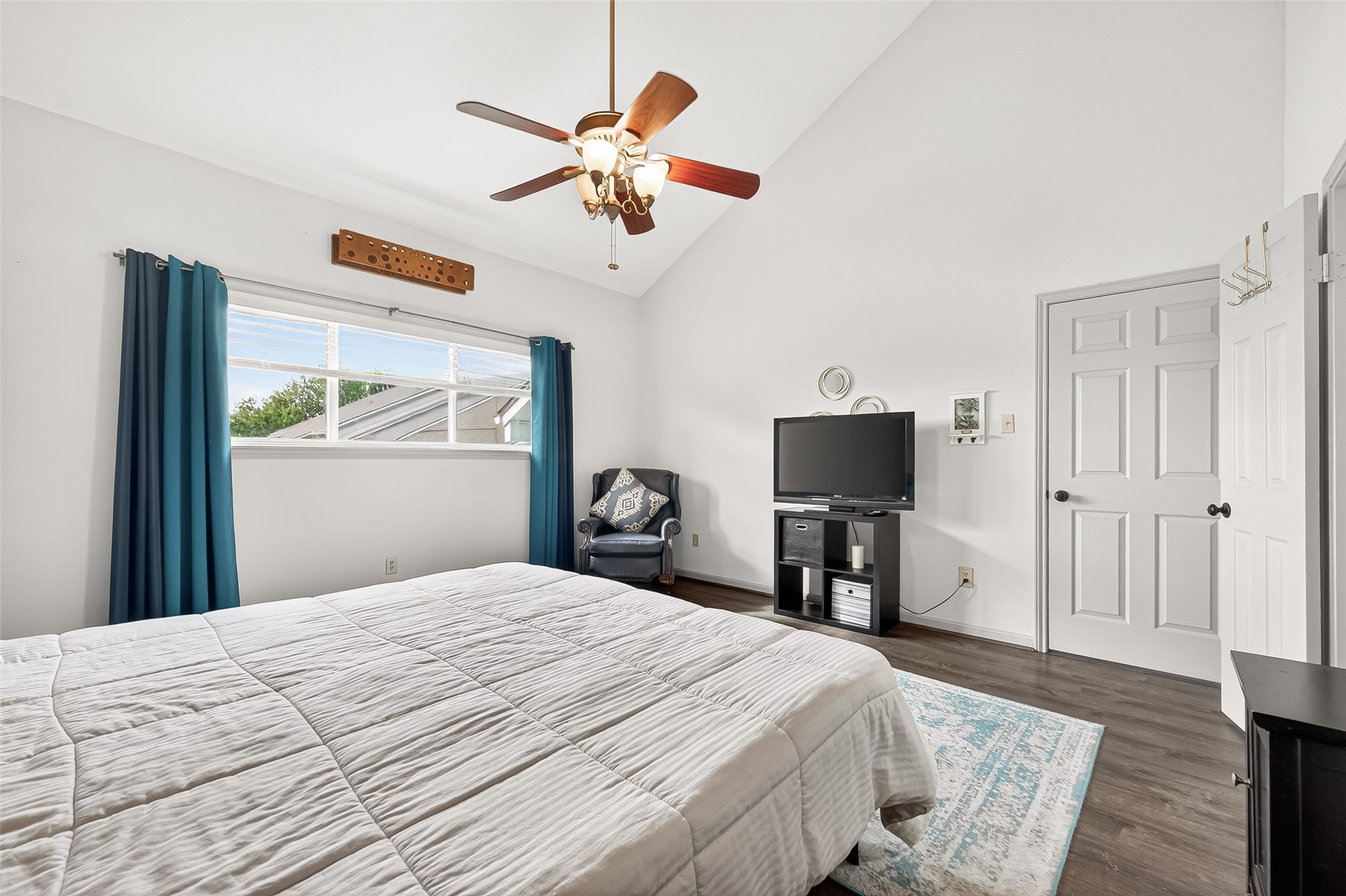 168 April Point Drive South, Unit 168 Conroe, TX 77356 - Photo 23 of 39 a bedroom with a bed and a chandelier
