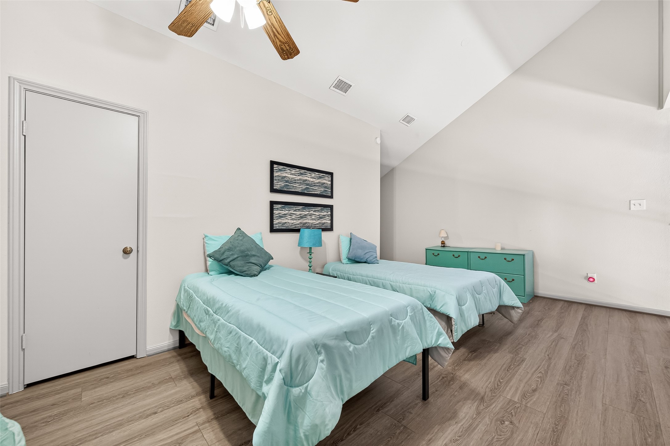 168 April Point Drive South, Unit 168 Conroe, TX 77356 - Photo 26 of 39 a bedroom with a bed and a chandelier