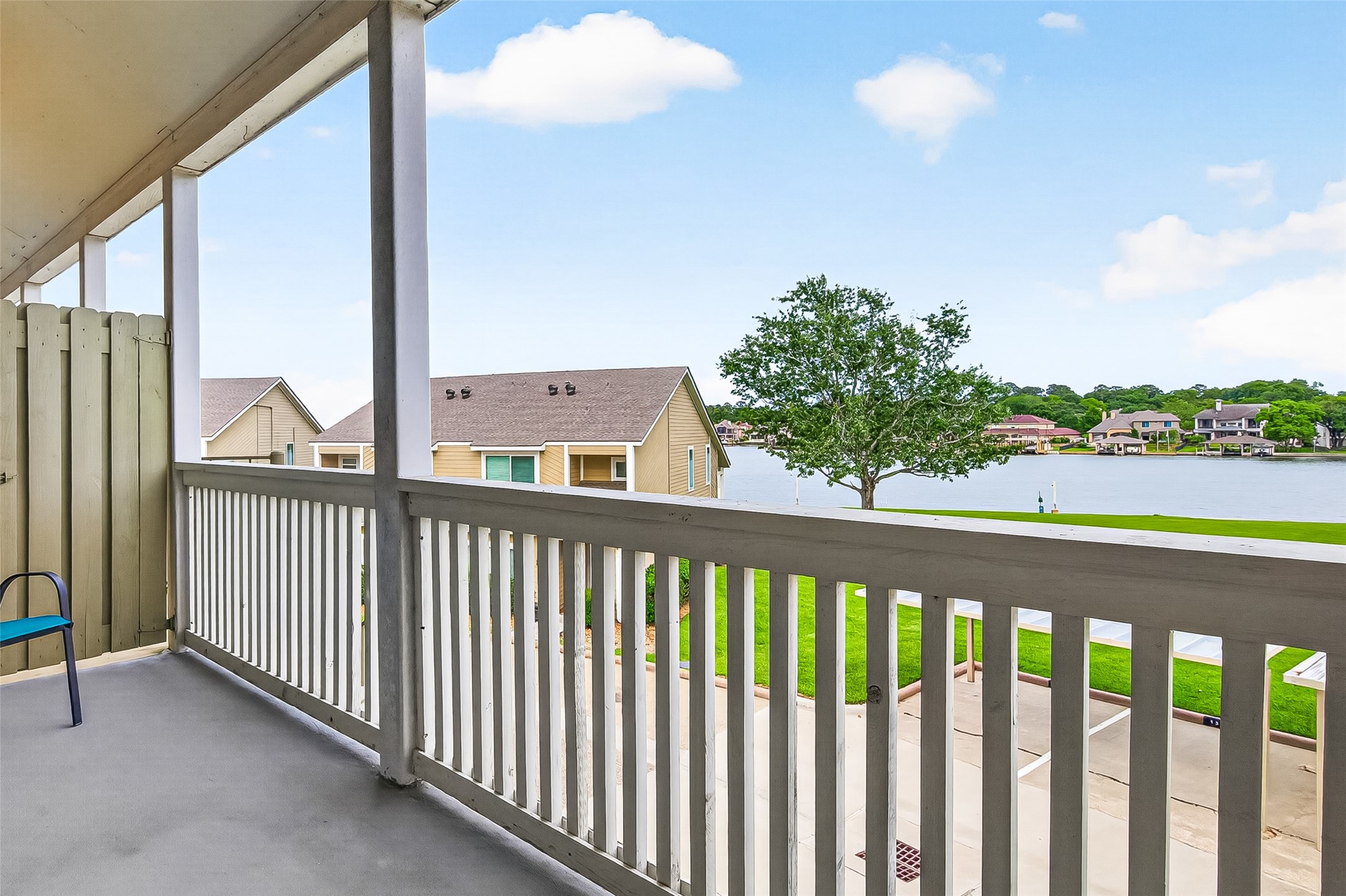 168 April Point Drive South, Unit 168 Conroe, TX 77356 - Photo 29 of 39 a view of a balcony with floor to ceiling window and wooden fence