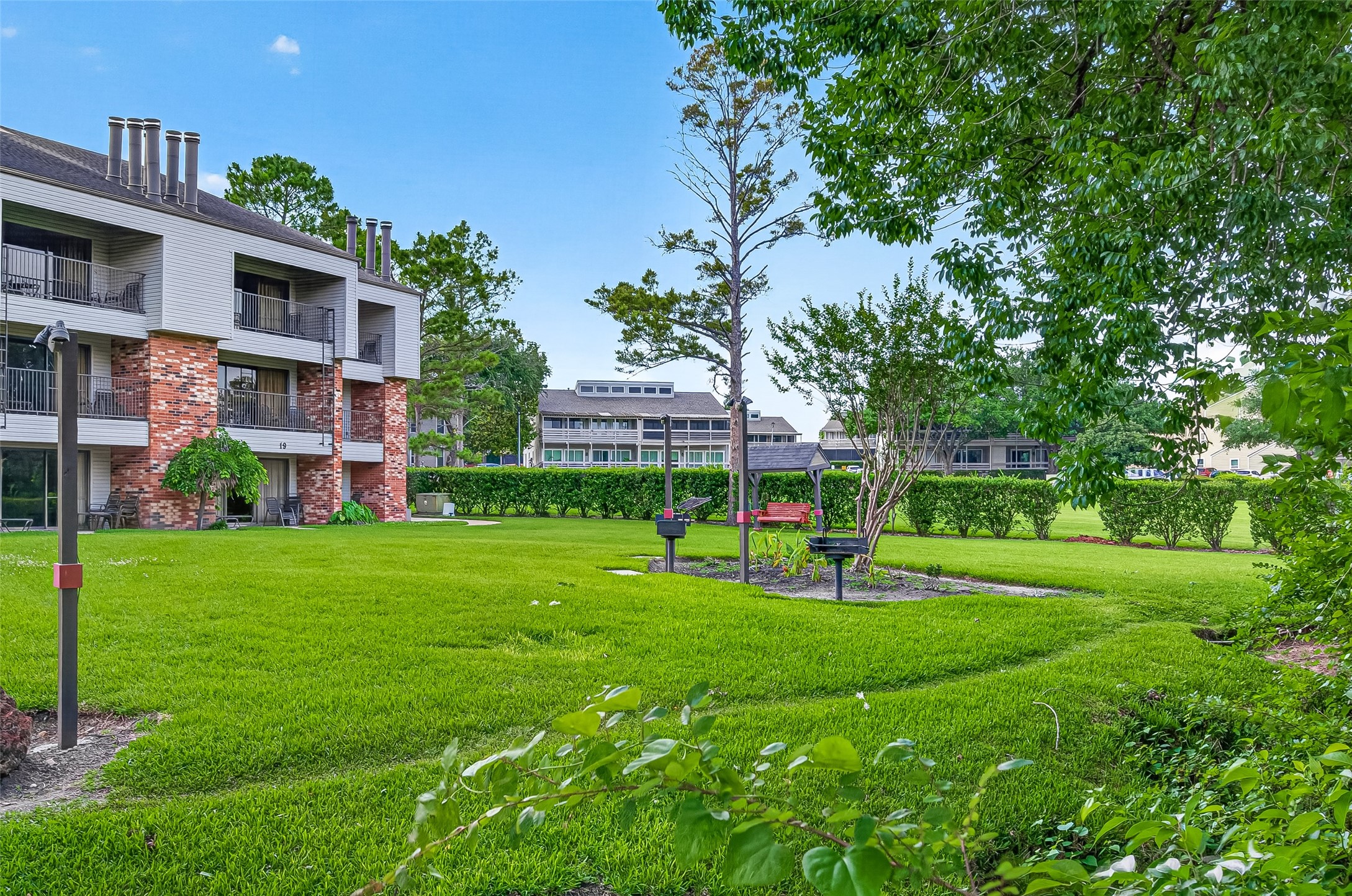168 April Point Drive South, Unit 168 Conroe, TX 77356 - Photo 32 of 39 a view of a big house with a big yard and large trees