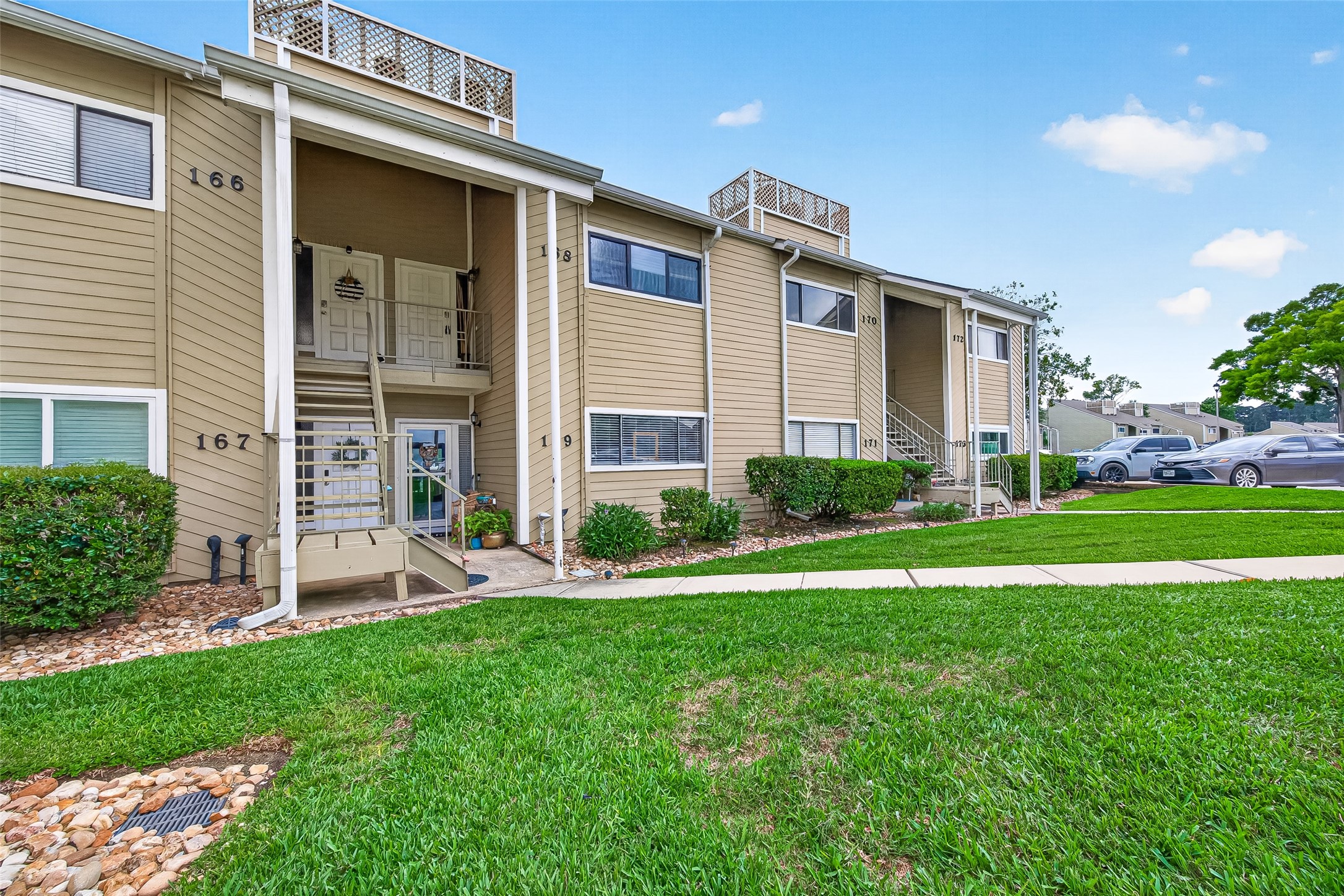 168 April Point Drive South, Unit 168 Conroe, TX 77356 - Photo 4 of 39 a front view of house with yard
