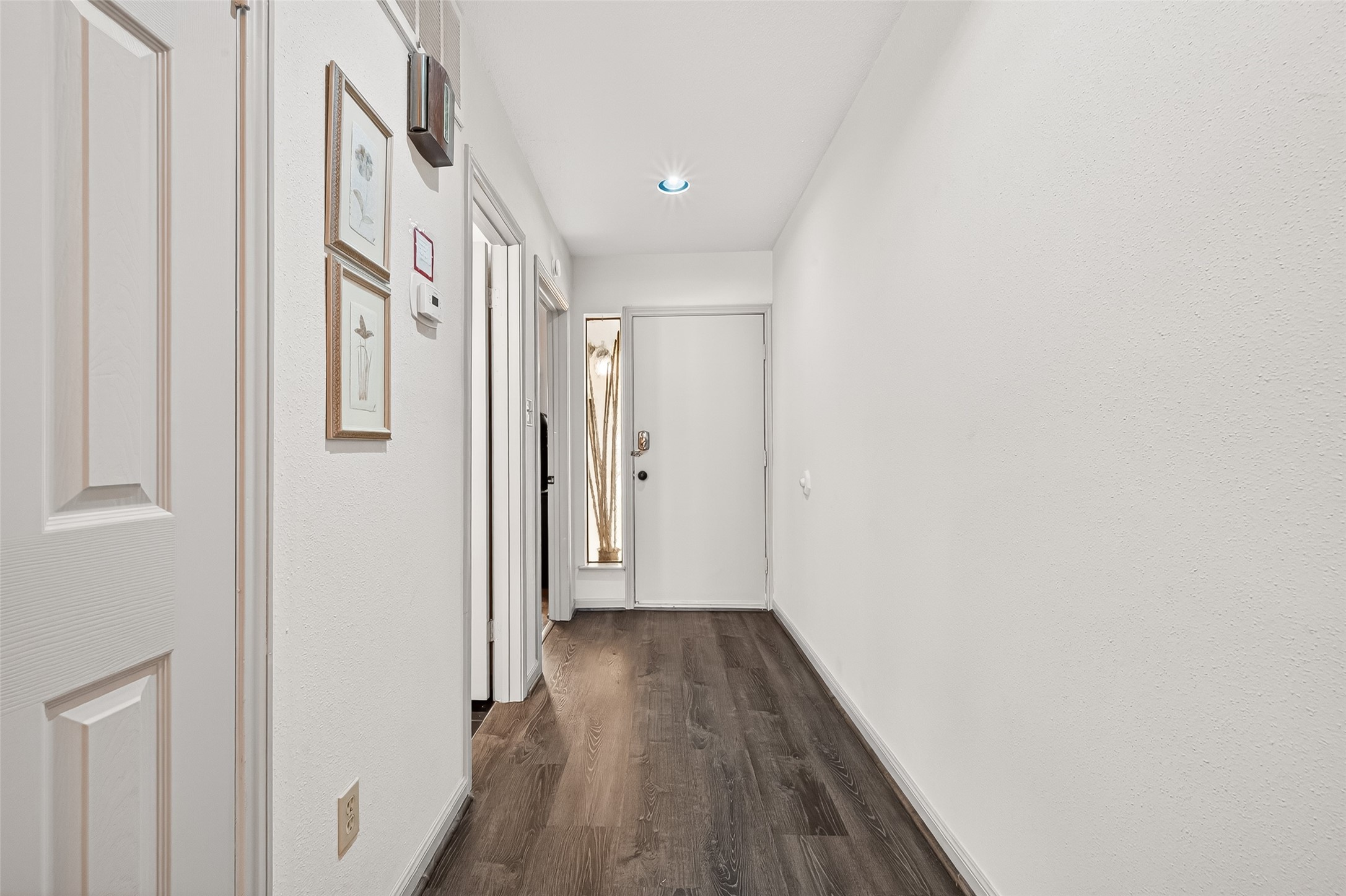 168 April Point Drive South, Unit 168 Conroe, TX 77356 - Photo 6 of 39 a view of a hallway with wooden floor and staircase