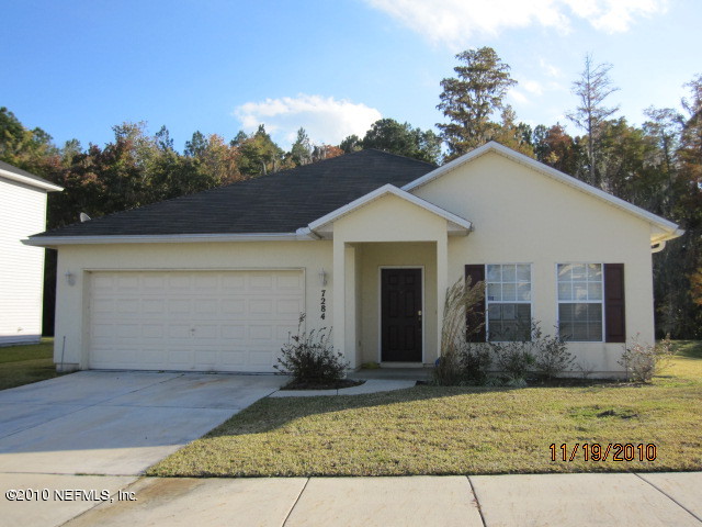 7284 Rampart Ridge Circle West Jacksonville, FL 32244 - Photo 1 of 9 a front view of a house with a yard and garage