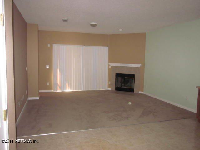 7284 Rampart Ridge Circle West Jacksonville, FL 32244 - Photo 3 of 9 a view of a livingroom with an empty space and a fireplace