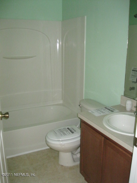 7284 Rampart Ridge Circle West Jacksonville, FL 32244 - Photo 5 of 9 a bathroom with a sink a toilet and shower