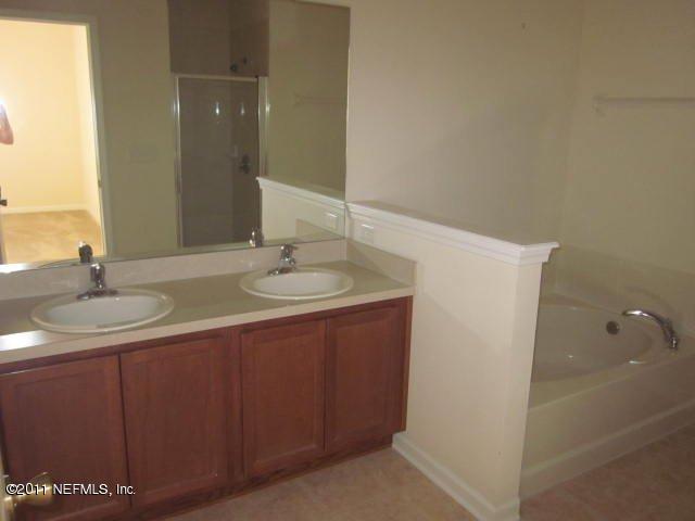 7284 Rampart Ridge Circle West Jacksonville, FL 32244 - Photo 6 of 9 a bathroom with a sink and a mirror