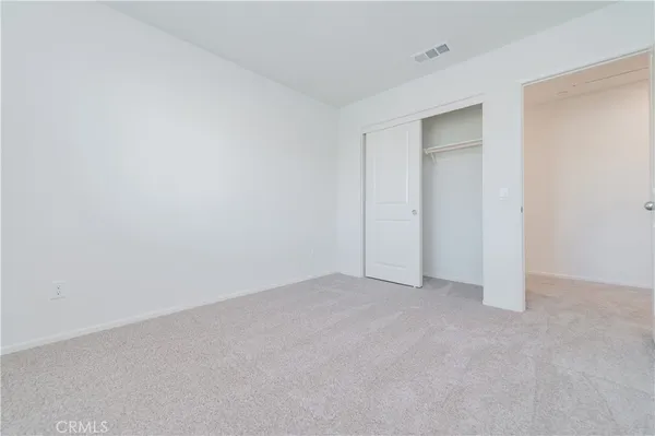 an empty room with closet area