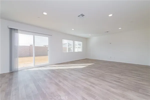 a large kitchen with granite countertop lots of counter space and stainless steel appliances
