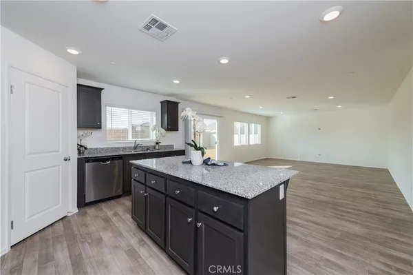 a kitchen with granite countertop a sink and a window