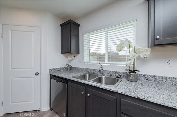 a kitchen with stainless steel appliances granite countertop a stove microwave and sink