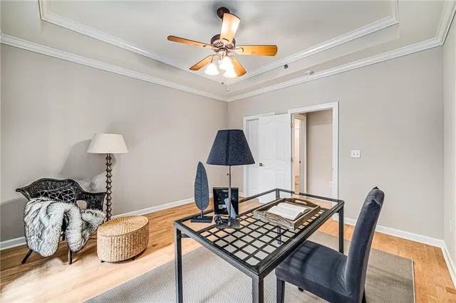 a room with furniture and a chandelier fan