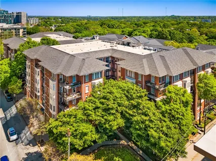 a view of a large building with a yard and plants