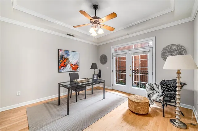 a work room with furniture and a large window