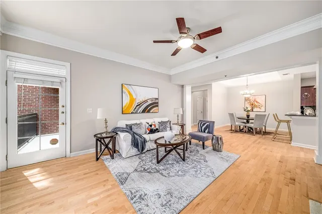 a view of a dining room with furniture a rug and wooden floor