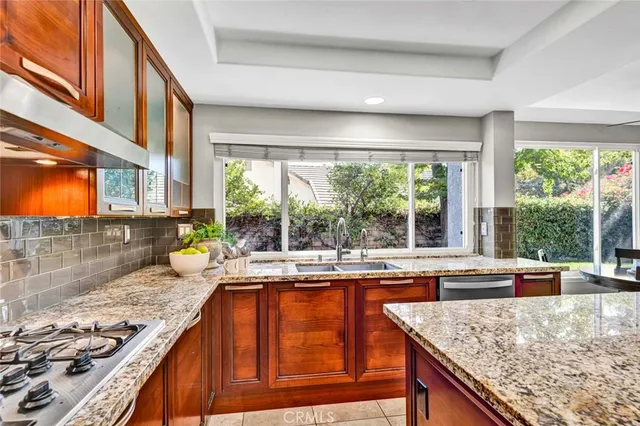a kitchen with large window appliances and cabinets