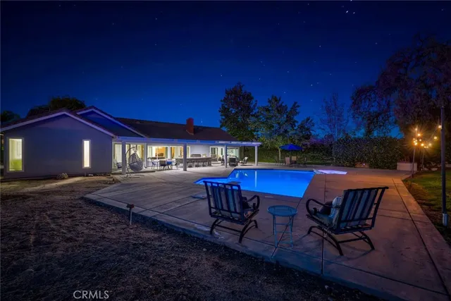 a view of a chairs and table in patio