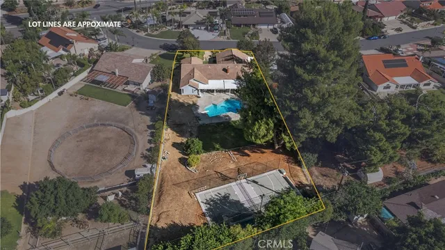 an aerial view of residential house with outdoor space and parking