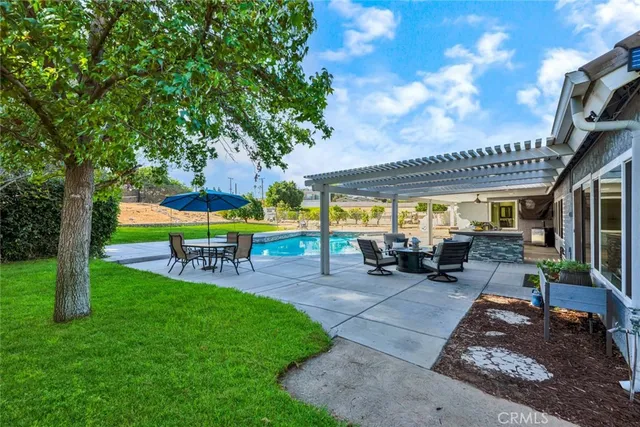 a view of a house with backyard porch and sitting area