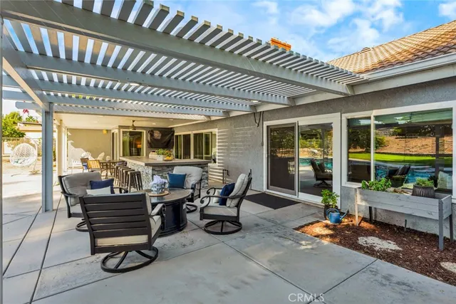 a building outdoor space with patio furniture and potted plants