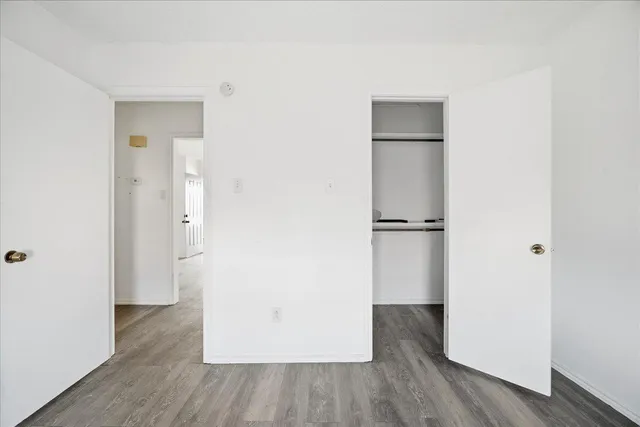 a view of a hallway with wooden floor
