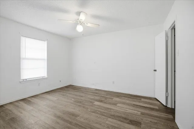an empty room with wooden floor and closet