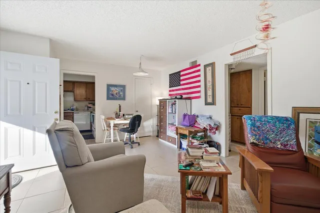 a view of a workspace with furniture and a bookshelf