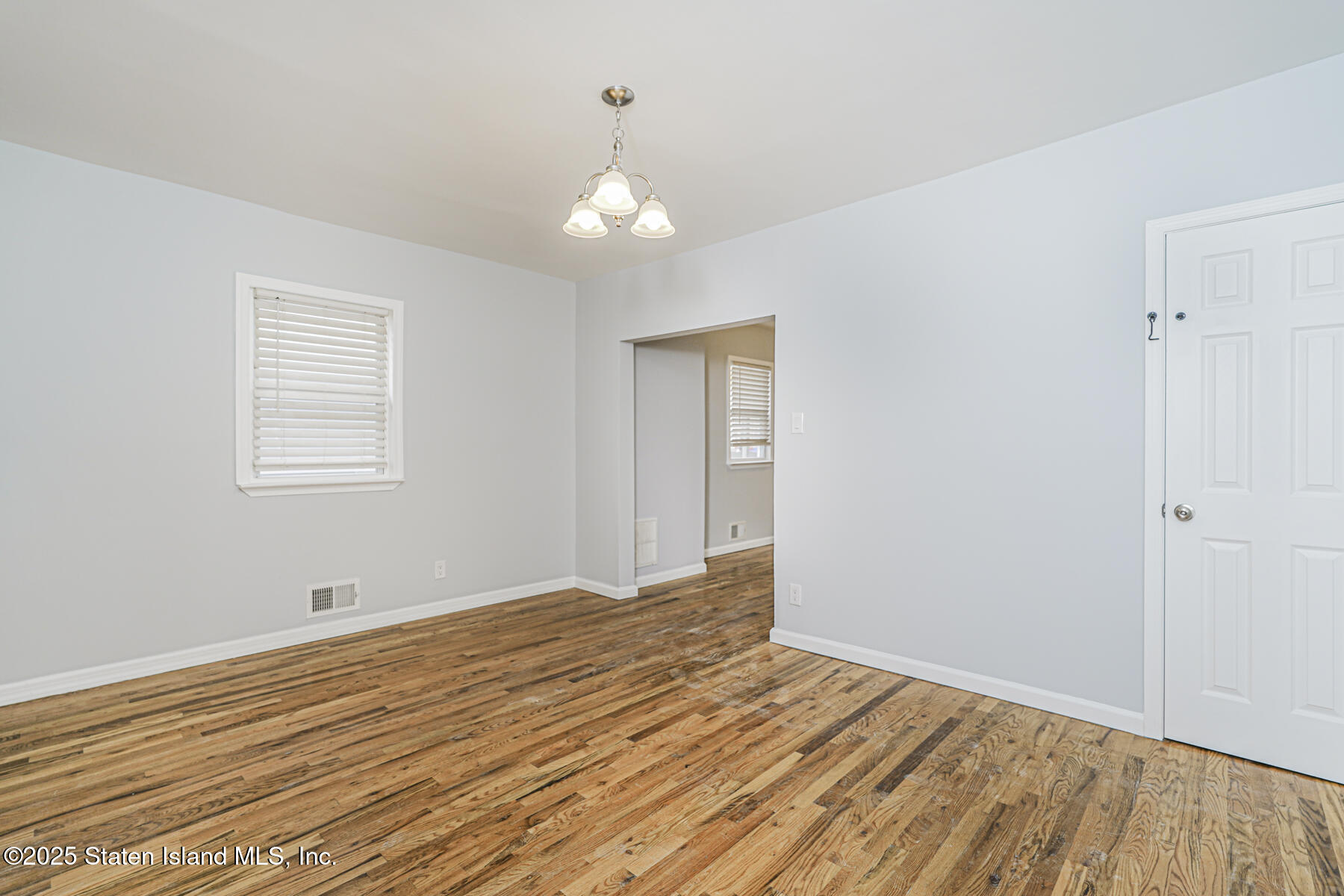 13 Laforge Avenue Staten Island, NY 10302 - Photo 18 of 31 a view of an empty room with wooden floor and a window