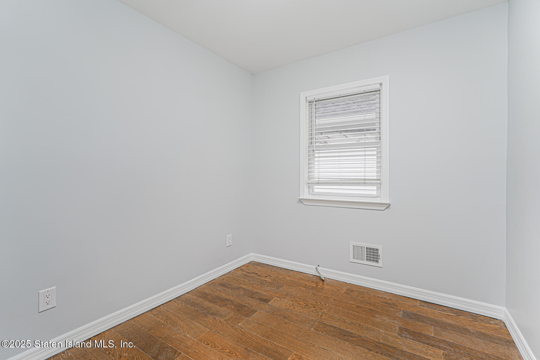 13 Laforge Avenue Staten Island, NY 10302 - Photo 20 of 31 a view of an empty room with wooden floor and a window