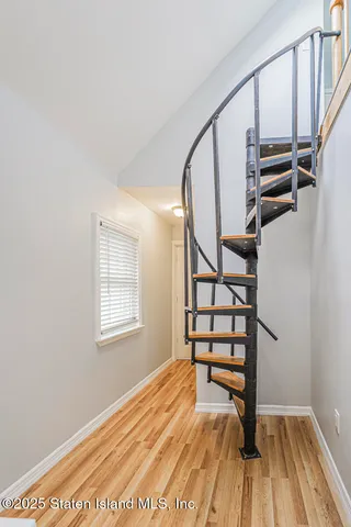 a view of entryway with wooden floor and stairs
