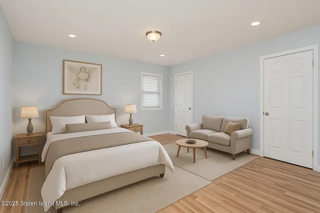 a bedroom with bed and a couch