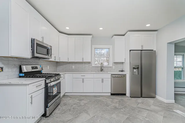 a kitchen with a sink stove and refrigerator