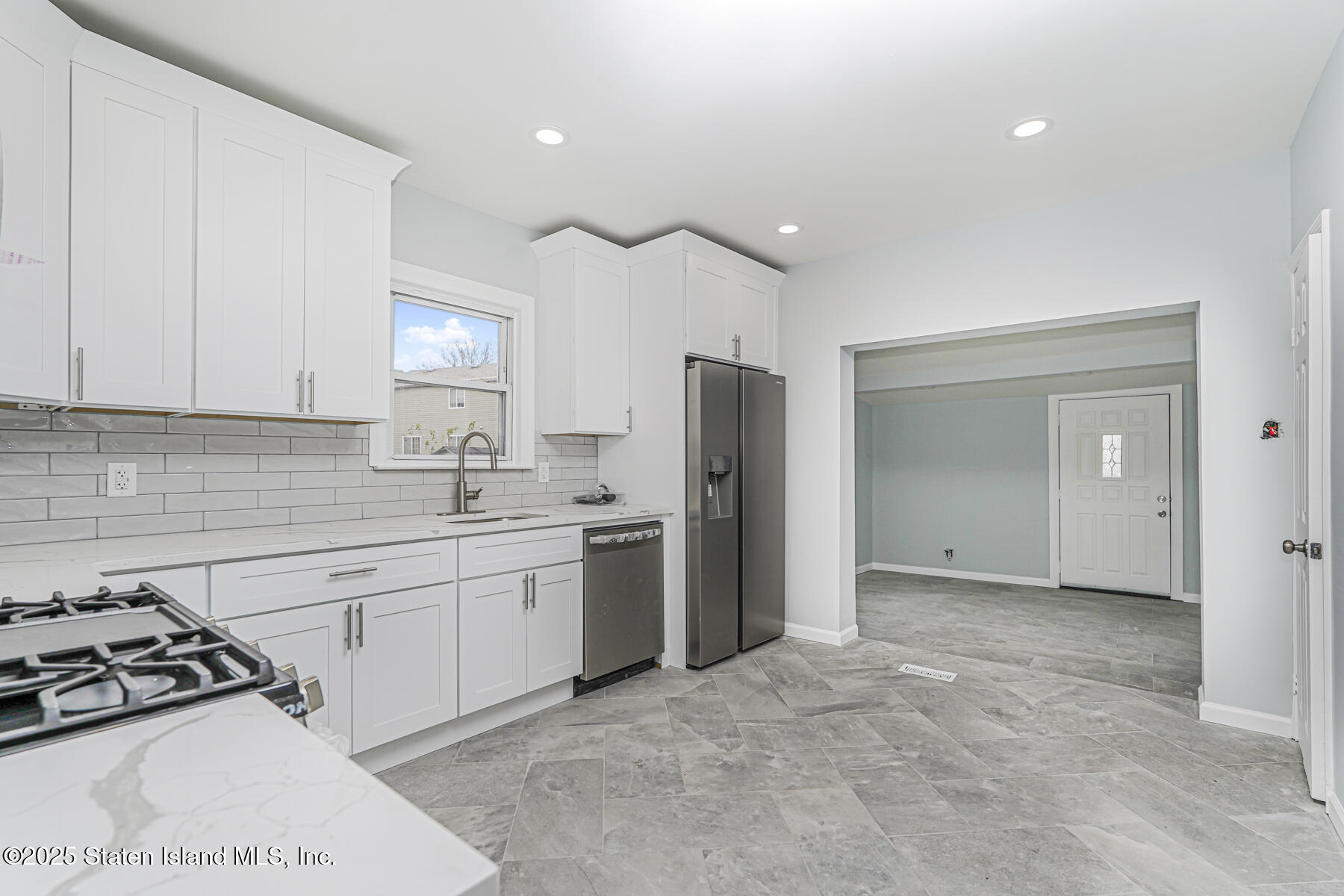 13 Laforge Avenue Staten Island, NY 10302 - Photo 7 of 31 a kitchen that has a refrigerator a sink and white cabinets