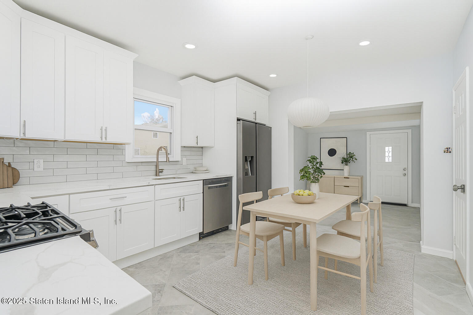 13 Laforge Avenue Staten Island, NY 10302 - Photo 9 of 31 a kitchen with a white stove a table and chairs in it