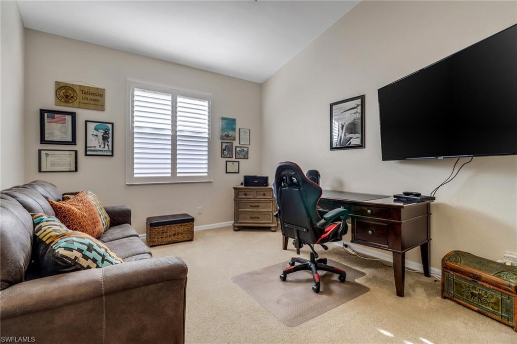 9146 Springview Loop Estero, FL 33928 - Photo 18 of 49 a view of a livingroom with workspace and a couch