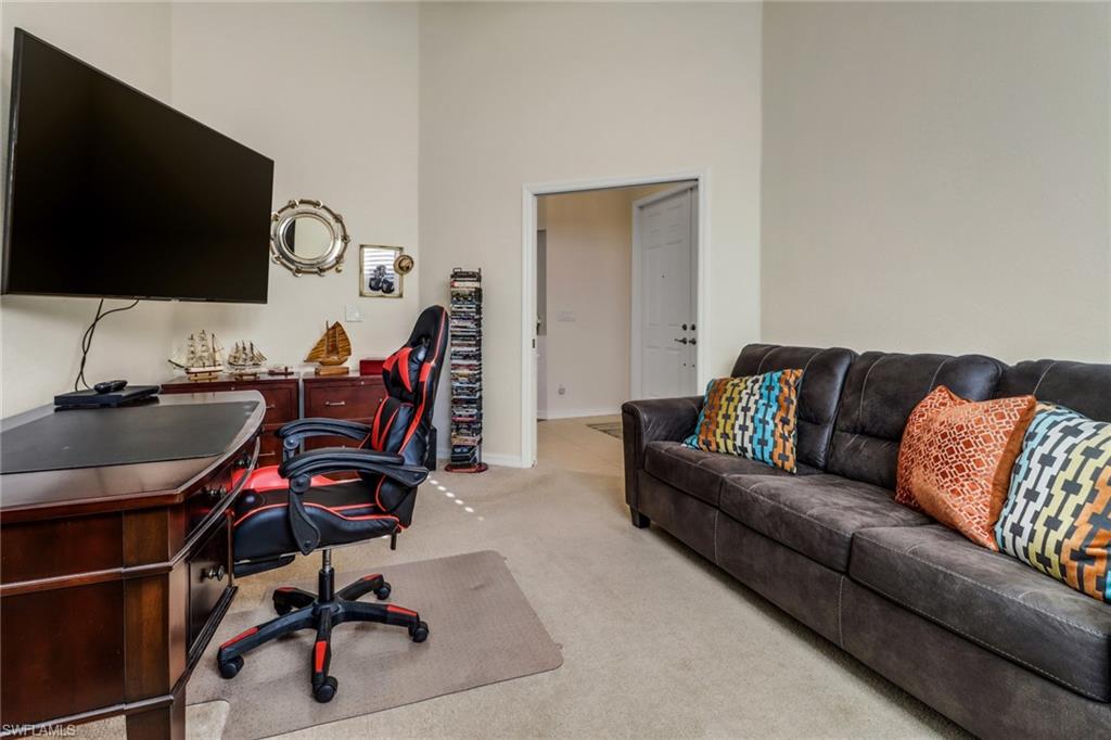 9146 Springview Loop Estero, FL 33928 - Photo 19 of 49 a living room with furniture and a flat screen tv