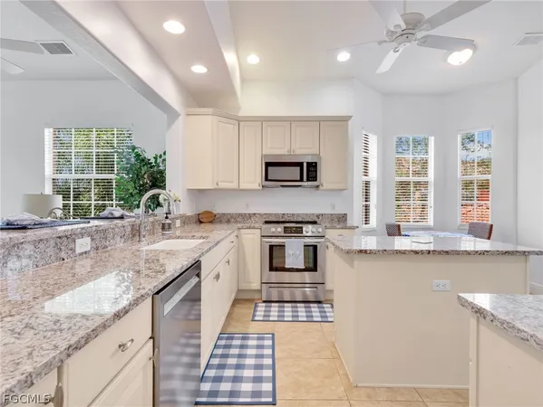 an aerial view of a residential houses with outdoor space and lake view