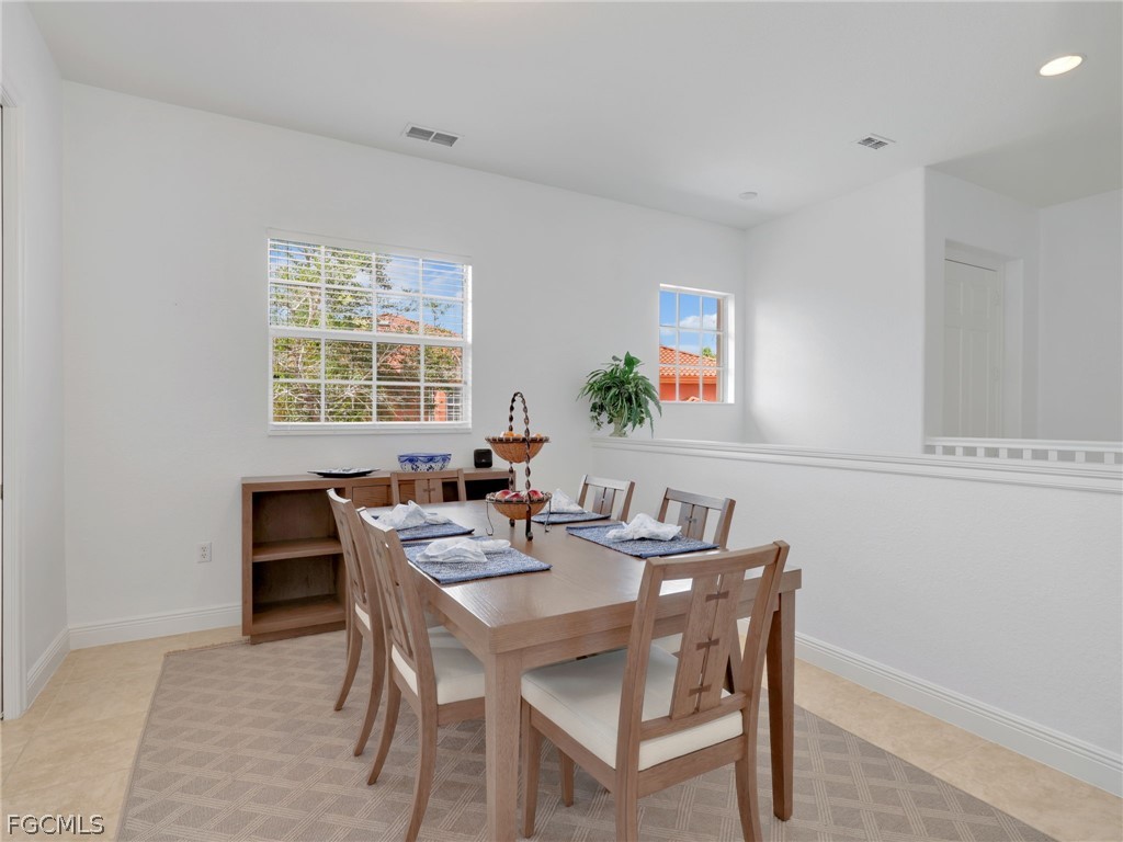 6422 Legacy Circle, Unit 704 Naples, FL 34113 - Photo 18 of 49 a view of a dining room with furniture and a window