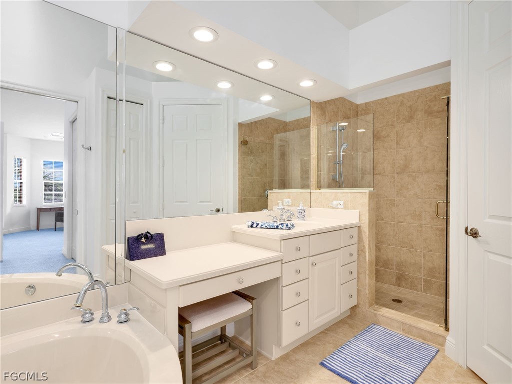 6422 Legacy Circle, Unit 704 Naples, FL 34113 - Photo 23 of 49 a bathroom with a double vanity sink mirror and shower
