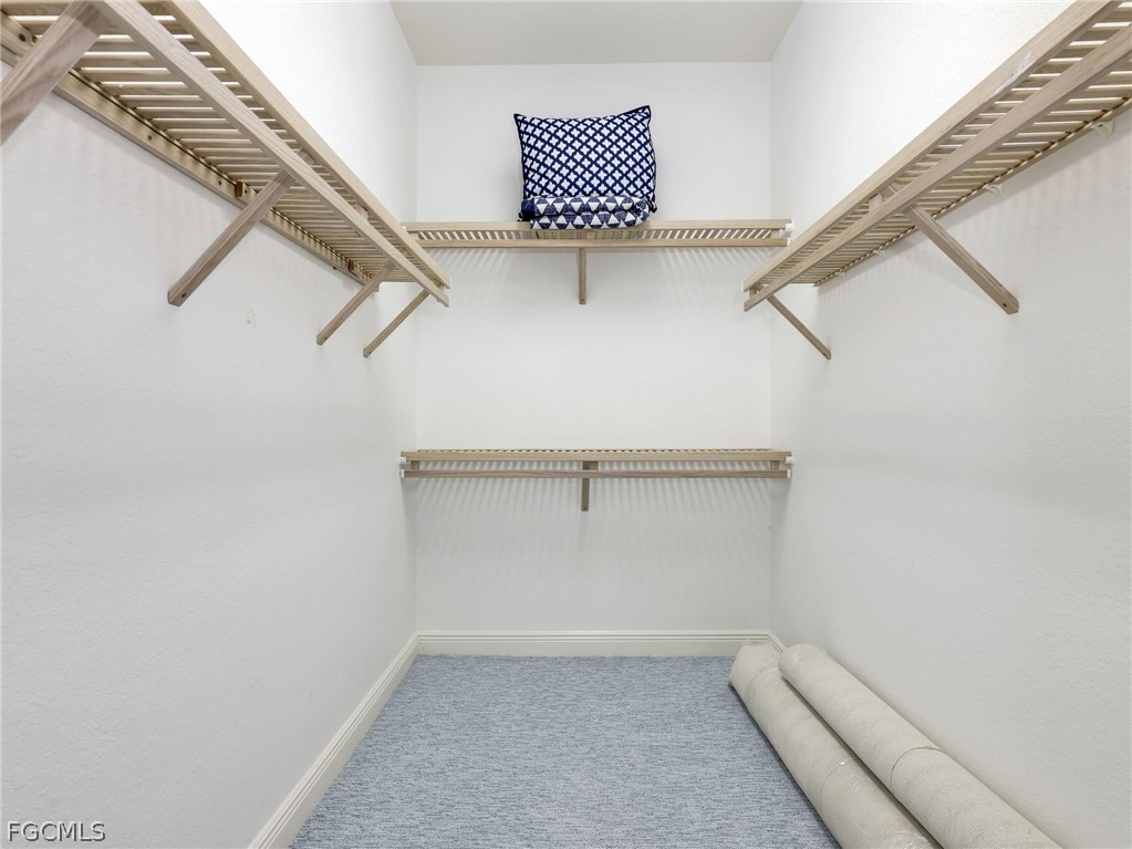 6422 Legacy Circle, Unit 704 Naples, FL 34113 - Photo 24 of 49 a view of a room with racks on the wall