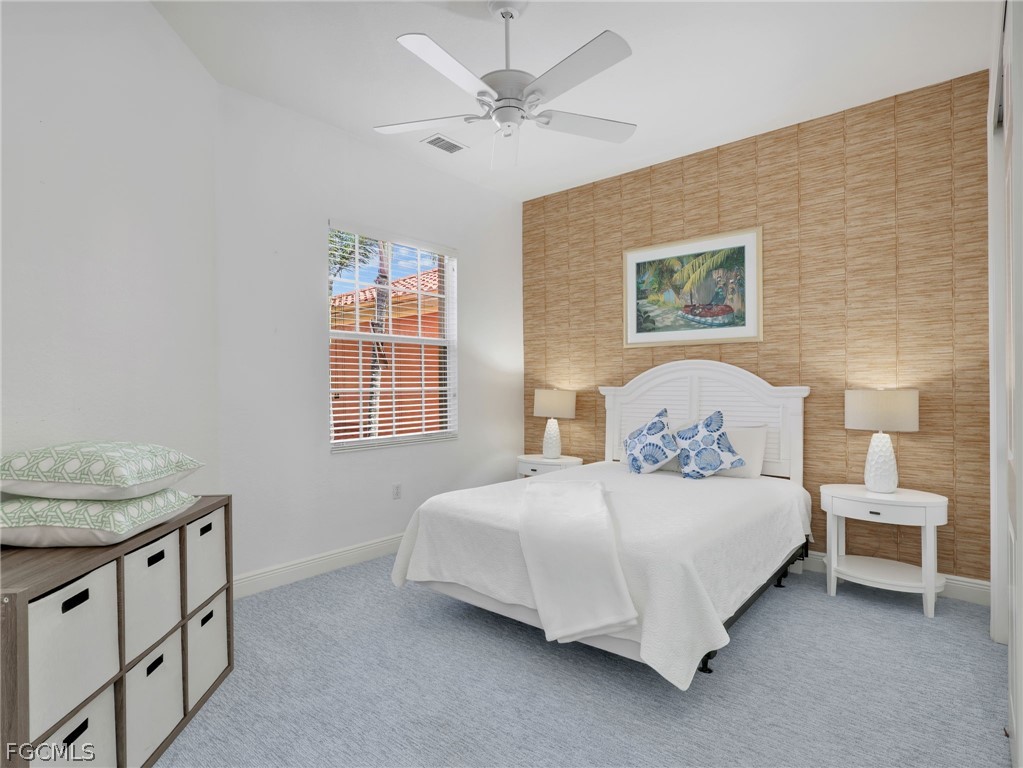 6422 Legacy Circle, Unit 704 Naples, FL 34113 - Photo 25 of 49 a bedroom with a bed dresser and a window