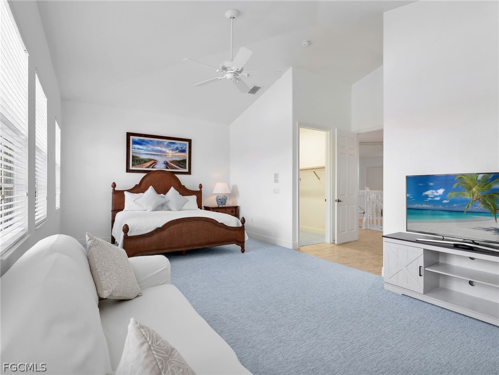 6422 Legacy Circle, Unit 704 Naples, FL 34113 - Photo 29 of 49 a bedroom with a bed and a flat screen tv