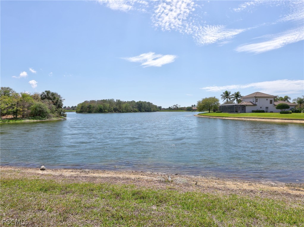 6422 Legacy Circle, Unit 704 Naples, FL 34113 - Photo 38 of 49 a view of a lake with houses in the background