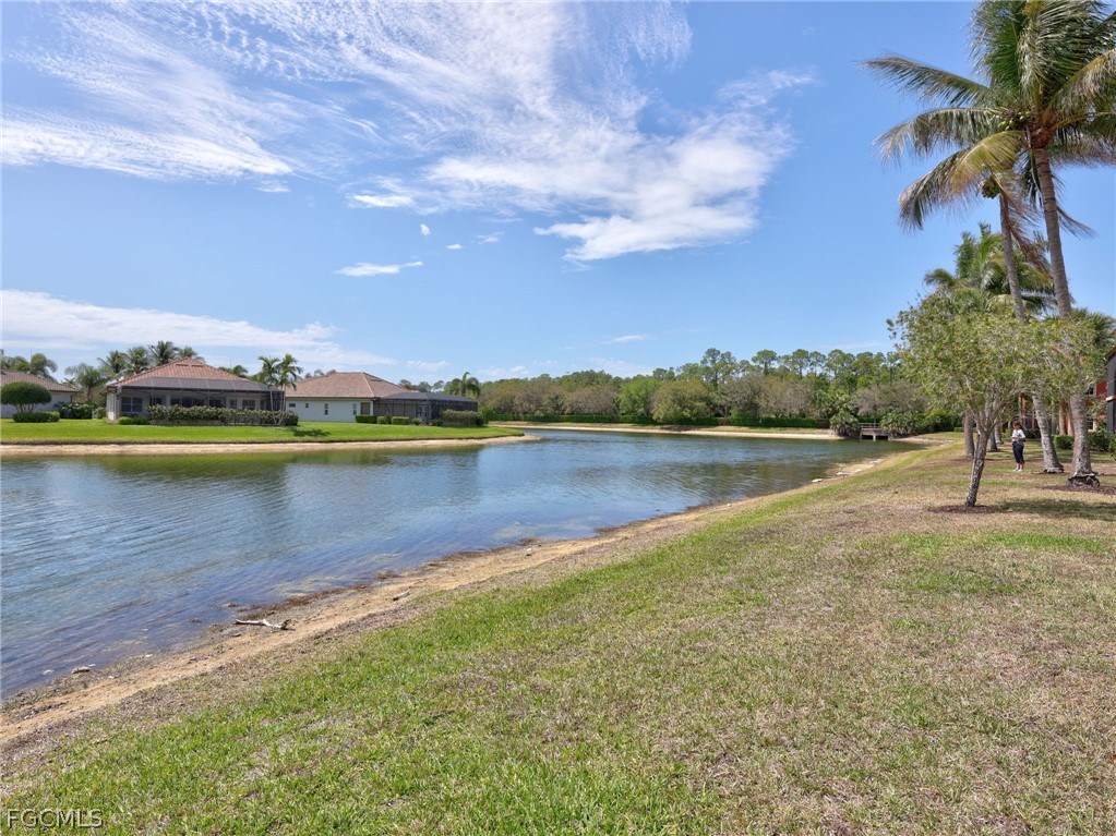 6422 Legacy Circle, Unit 704 Naples, FL 34113 - Photo 40 of 49 a view of a lake with houses in the background