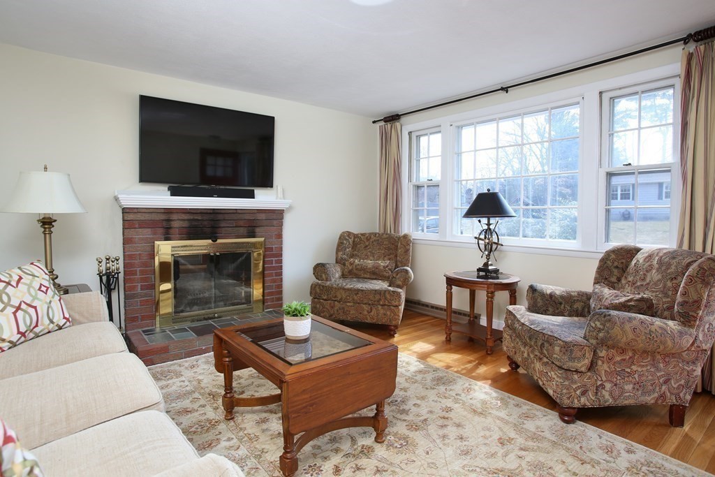 36 Donnell Road Walpole, MA 02032 - Photo 3 of 20 a living room with furniture a flat screen tv and a fireplace