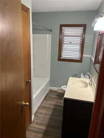 a bathroom with a sink a mirror and a bathtub