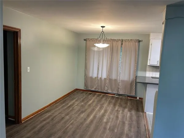 a view of a room with wooden floor and window