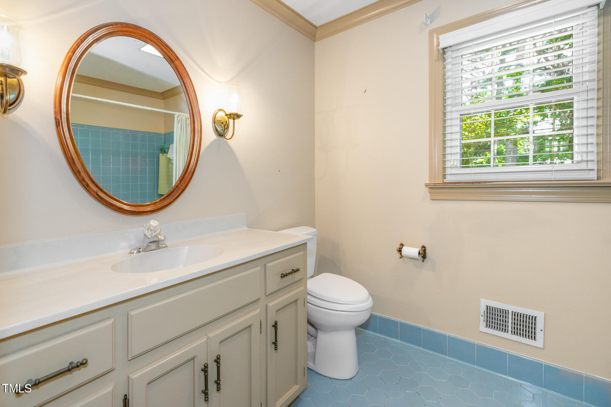 6904 Aspen Court Raleigh, NC 27615 - Photo 14 of 51 a bathroom with a sink a toilet and a mirror
