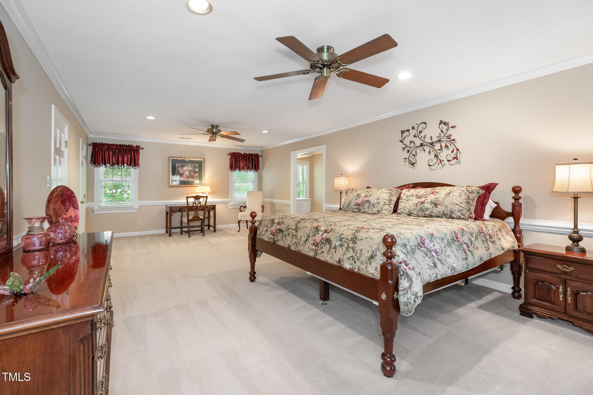 6904 Aspen Court Raleigh, NC 27615 - Photo 30 of 51 a bedroom with a bed and a chandelier