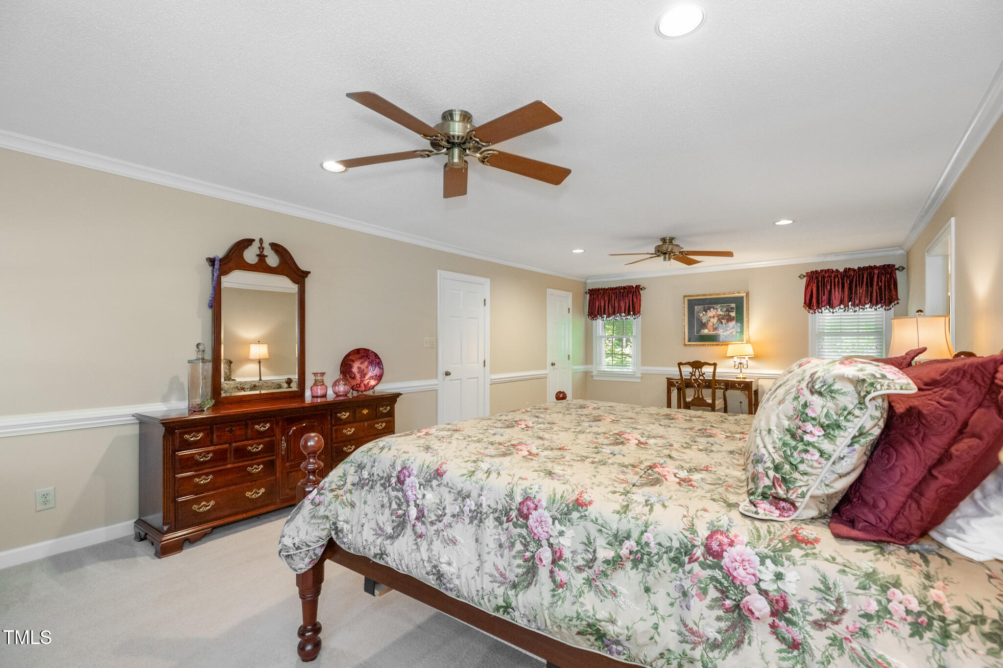 6904 Aspen Court Raleigh, NC 27615 - Photo 31 of 51 a bedroom with a bed and dresser with mirror