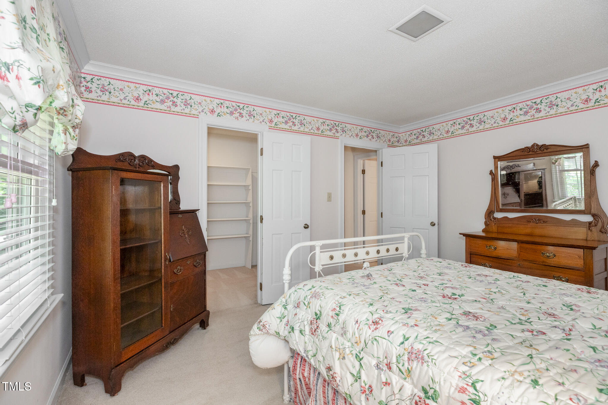 6904 Aspen Court Raleigh, NC 27615 - Photo 39 of 51 a bedroom with a bed and a mirror on the dresser